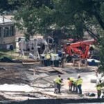 Crews remove the granite seal on the White House helipad, signaling potential project delays
